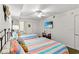 Bright bedroom featuring two beds, a ceiling fan, and a flat-screen TV for relaxed, comfortable living at 1401 S Ocean Blvd. # 506, North Myrtle Beach, SC 29582