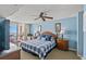 Comfortable bedroom featuring a spacious bed, balcony access, and a ceiling fan at 1401 S Ocean Blvd. # 506, North Myrtle Beach, SC 29582