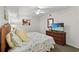 Bedroom featuring a TV, bedside tables, and a comfortable bed with a patterned quilt at 1401 S Ocean Blvd. # 506, North Myrtle Beach, SC 29582