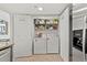 Functional laundry room with a washer, dryer, and shelving for efficient storage and organization at 1401 S Ocean Blvd. # 506, North Myrtle Beach, SC 29582