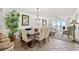 Open-concept living and dining area with an ocean view through a sliding door and large windows at 1401 S Ocean Blvd. # 506, North Myrtle Beach, SC 29582