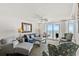 Cozy living room with comfortable seating and an ocean view from a balcony at 1401 S Ocean Blvd. # 506, North Myrtle Beach, SC 29582