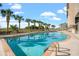 Sunny outdoor pool with clear blue water and palm trees at 1401 S Ocean Blvd. # 506, North Myrtle Beach, SC 29582