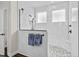 Modern bathroom featuring white marble tile, glass-enclosed shower, and sleek black fixtures at 143 Starlit Way, Myrtle Beach, SC 29579