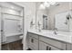 Bright bathroom featuring a double vanity, white cabinets, and tub-shower combo at 143 Starlit Way, Myrtle Beach, SC 29579