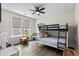 Cozy bedroom with a bunk bed, a colorful table, and two large windows at 143 Starlit Way, Myrtle Beach, SC 29579