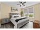 Bright bedroom featuring a gray bed, neutral walls, and large windows overlooking greenery at 143 Starlit Way, Myrtle Beach, SC 29579