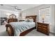 Cozy bedroom with a wood sleigh bed, dresser, nightstands and neutral walls at 143 Starlit Way, Myrtle Beach, SC 29579