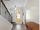 Foyer with hardwood floors, staircase, and a bright yellow front door at 143 Starlit Way, Myrtle Beach, SC 29579