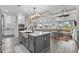 Open-concept kitchen with a large island, modern appliances, and an adjacent living area at 143 Starlit Way, Myrtle Beach, SC 29579