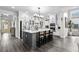 Bright kitchen features a large center island, stainless steel appliances, and gray wood flooring at 143 Starlit Way, Myrtle Beach, SC 29579