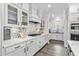 Bright kitchen features white cabinets, a mosaic backsplash, and modern appliances at 143 Starlit Way, Myrtle Beach, SC 29579