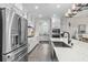 Modern kitchen showcasing white cabinetry, stainless steel appliances, and a stylish central island at 143 Starlit Way, Myrtle Beach, SC 29579