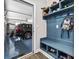 Mudroom with blue built-in bench and shoe storage, open to a garage with epoxy flooring at 143 Starlit Way, Myrtle Beach, SC 29579