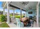Covered patio with multiple ceiling fans, a view of the yard and lake at 143 Starlit Way, Myrtle Beach, SC 29579