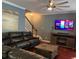 Comfortable living room with a fireplace, large sectional couch, and a ceiling fan at 1440 Brighton Ave., Myrtle Beach, SC 29588