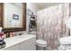 Well-lit bathroom with ornate mirror, vanity, and shower at 146 Stillwood Dr. # 3, Pawleys Island, SC 29585