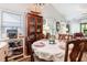 Elegant dining room with vaulted ceilings, chandelier, and large china cabinet, next to the living room at 146 Stillwood Dr. # 3, Pawleys Island, SC 29585