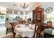 Elegant dining room with vaulted ceilings, chandelier, and large china cabinet, next to the kitchen at 146 Stillwood Dr. # 3, Pawleys Island, SC 29585