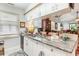Kitchen with granite countertops, stainless steel sink, white cabinetry, and an open view to the dining area at 146 Stillwood Dr. # 3, Pawleys Island, SC 29585