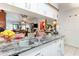 Bright kitchen featuring marble countertops, white cabinetry, and stainless steel sink at 146 Stillwood Dr. # 3, Pawleys Island, SC 29585