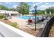 Community pool with lounge chairs and blue umbrellas at 146 Stillwood Dr. # 3, Pawleys Island, SC 29585