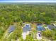 Panoramic aerial view of a lovely home surrounded by lush greenery and serene wooded areas at 1610 Old Tram Rd., Little River, SC 29566