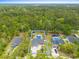 Expansive aerial view of a beautiful home with a sprawling yard and inviting pool area at 1610 Old Tram Rd., Little River, SC 29566