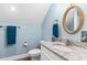 Well-lit bathroom with granite countertops, a rope-style mirror, and blue accents at 1610 Old Tram Rd., Little River, SC 29566