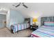 The bedroom features twin beds with colorful striped bedding and a ceiling fan at 1610 Old Tram Rd., Little River, SC 29566