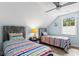 This charming bedroom features two twin beds, a ceiling fan, and a bright window at 1610 Old Tram Rd., Little River, SC 29566