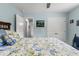 Bright bedroom with closet, carpeted floors, and floral bedding, offering a comfortable retreat at 1610 Old Tram Rd., Little River, SC 29566