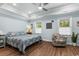Spacious bedroom with tray ceiling, large windows, and a sitting area at 1610 Old Tram Rd., Little River, SC 29566