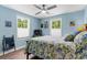 Bright bedroom with two windows, ceiling fan, floral bedding and carpeted floors at 1610 Old Tram Rd., Little River, SC 29566