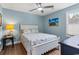 Cozy bedroom features a ceiling fan, beach-themed decor, and a sunny window at 1610 Old Tram Rd., Little River, SC 29566