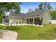 Manicured front yard with green lawn, shrubs, and stone accents at 1610 Old Tram Rd., Little River, SC 29566