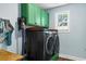 Well-equipped laundry room featuring modern washer and dryer set and built-in storage at 1610 Old Tram Rd., Little River, SC 29566