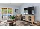 Bright living room with hardwood floors and a sliding glass door to the backyard at 1610 Old Tram Rd., Little River, SC 29566