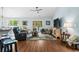 Bright living room with hardwood floors and a sliding glass door to the backyard at 1610 Old Tram Rd., Little River, SC 29566