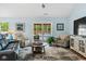 Bright living room with hardwood floors and a sliding glass door to the backyard at 1610 Old Tram Rd., Little River, SC 29566