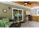 Inviting covered outdoor patio with ceiling fan, TV, and comfortable seating area at 1610 Old Tram Rd., Little River, SC 29566