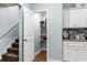 Kitchen pantry with ample shelving next to the staircase and white cabinets at 1610 Old Tram Rd., Little River, SC 29566