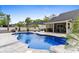 Backyard pool surrounded by palm trees and patio furniture at 1610 Old Tram Rd., Little River, SC 29566