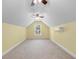 Finished attic space with carpeting, window, yellow walls, and a mini split system at 1674 Sw Beach Dr., Calabash, SC 28467