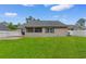 Manicured backyard with lush green lawn, screen porch and white vinyl fence at 1674 Sw Beach Dr., Calabash, SC 28467