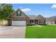 Beautiful single-story home with well-kept lawn, attached garage, and inviting front porch at 1674 Sw Beach Dr., Calabash, SC 28467