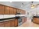 Well-lit kitchen boasts stainless steel appliances, granite counters, and ample cabinetry for storage at 1674 Sw Beach Dr., Calabash, SC 28467