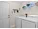 Laundry room with newer washer and dryer appliances and tile flooring at 1674 Sw Beach Dr., Calabash, SC 28467