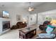 Bright and airy living room featuring a fireplace, ceiling fan, and plush seating arrangements at 1674 Sw Beach Dr., Calabash, SC 28467