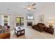 Cozy living room with fireplace, ceiling fan, and sliding glass doors to outdoor space at 1674 Sw Beach Dr., Calabash, SC 28467